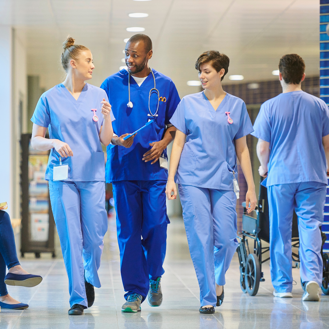 NHS workers walking through hospital