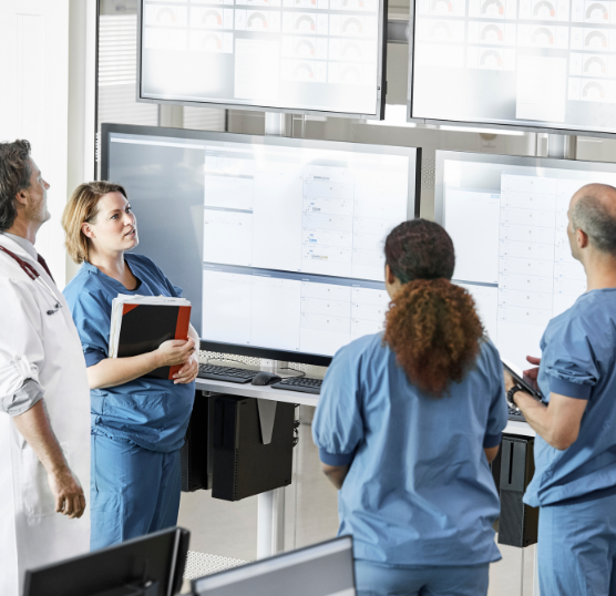 hospital workers around screens talking